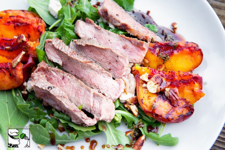 Sliced ribeye with grilled peach salad is the perfect end of summer meal.
