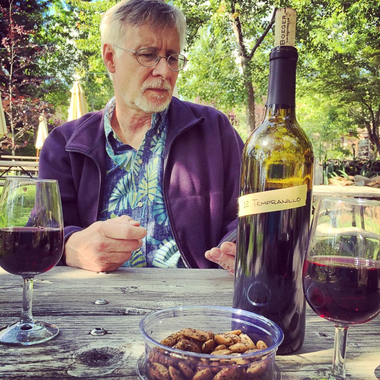 Yes!Chef! checking his messages on the phone while his wife takes pictures of everything in front of her